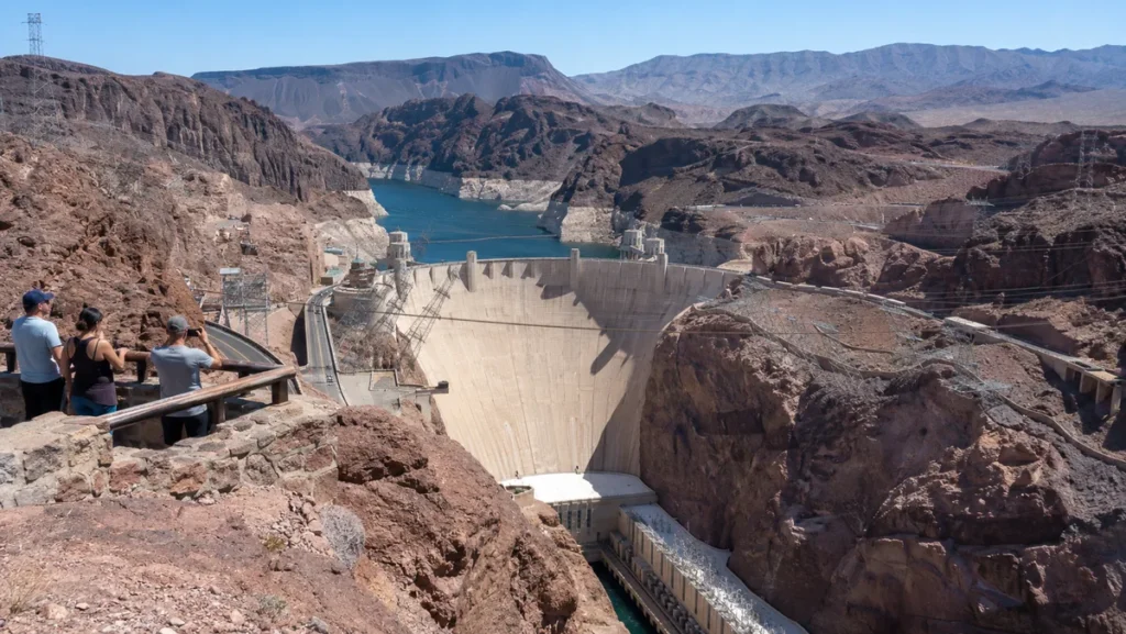 Hoover Dam viewed from an elevated overlook surrounded by desert terrain.
