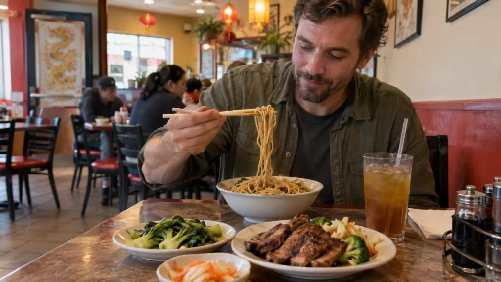 Male traveler eating noodles and grilled meat at a casual restaurant in Las Vegas Chinatown.